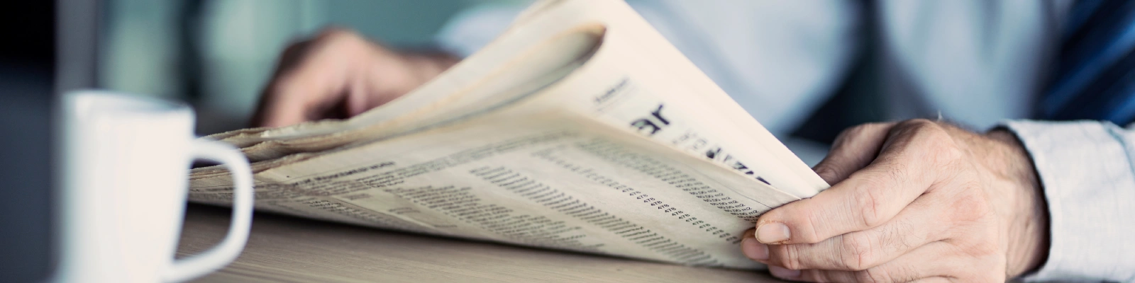 image of someone reading a newspaper